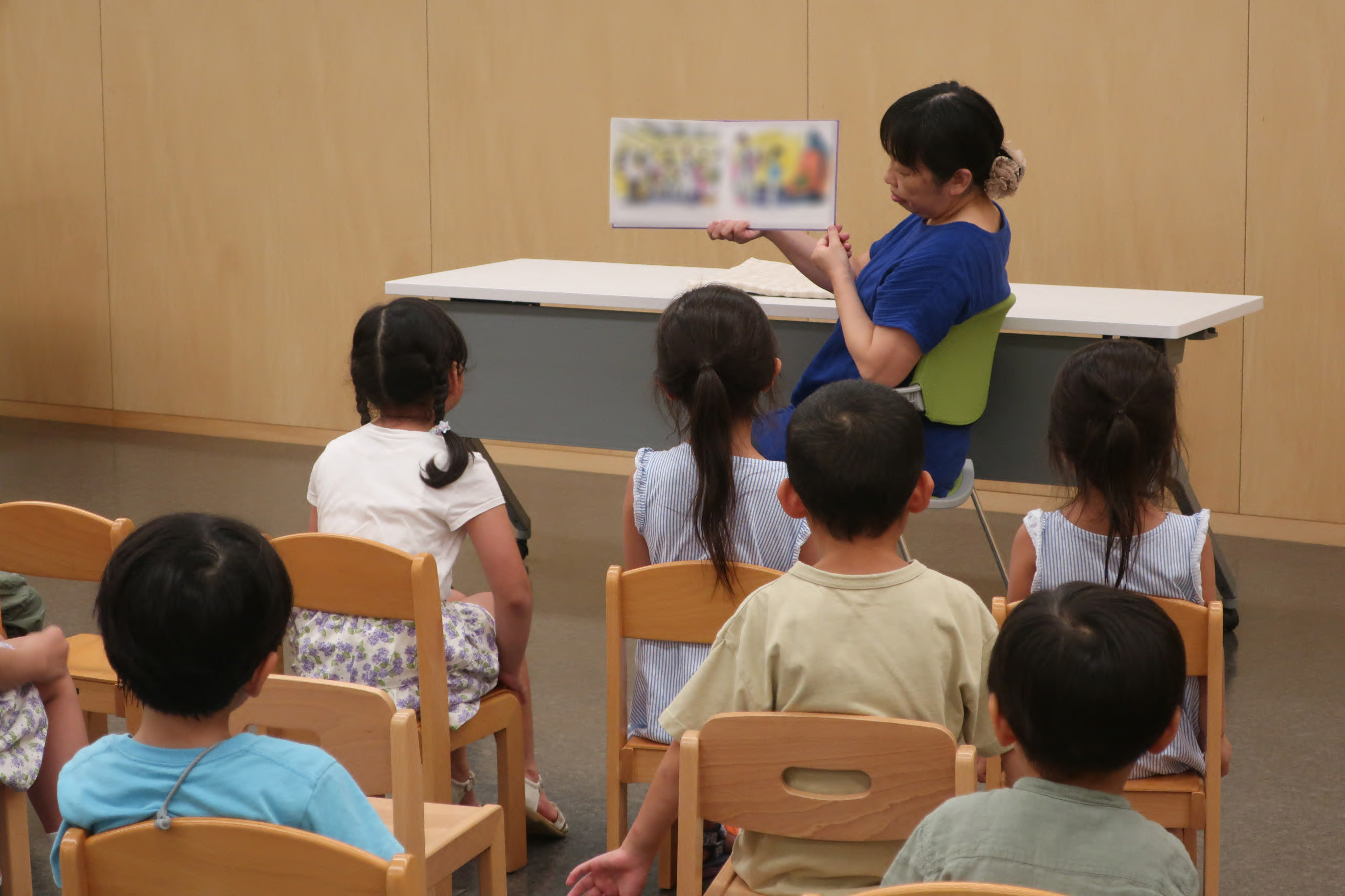 A library staff member reading from a picture book